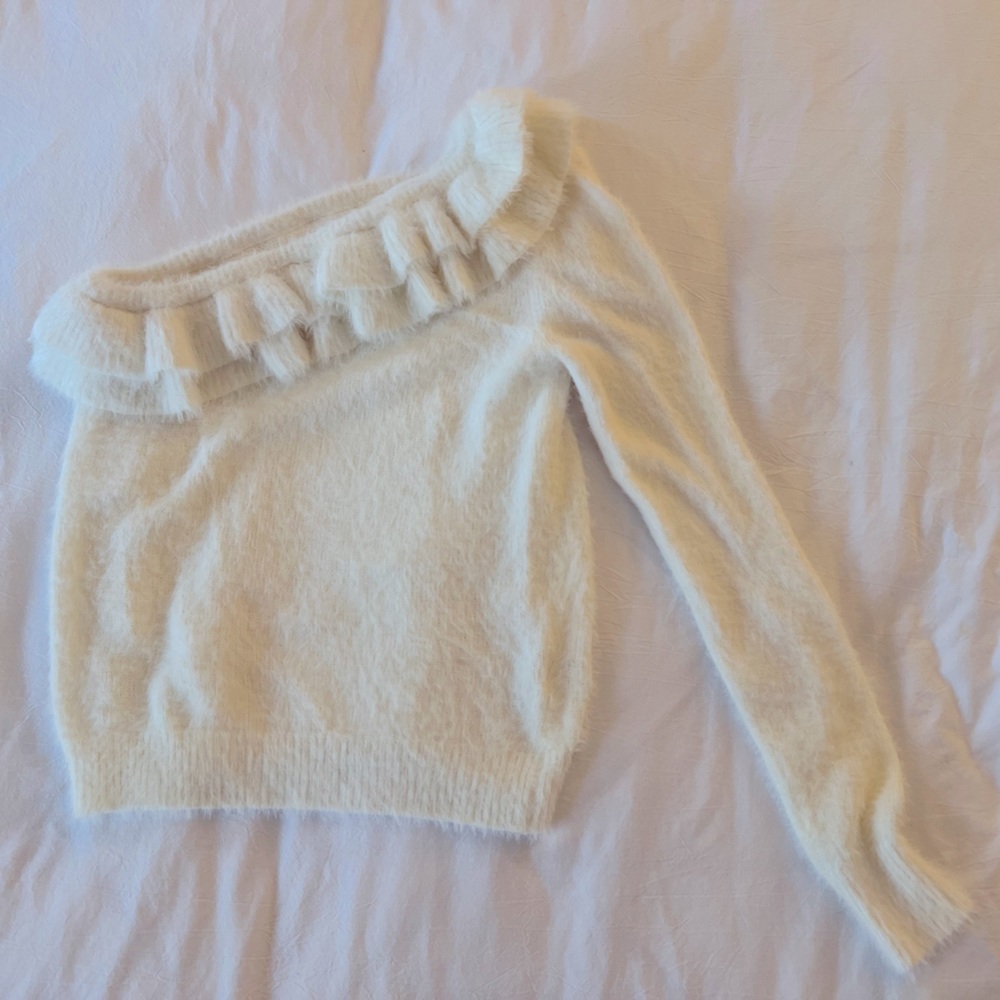 DO+BE one-shoulder sweater with ruffle details.